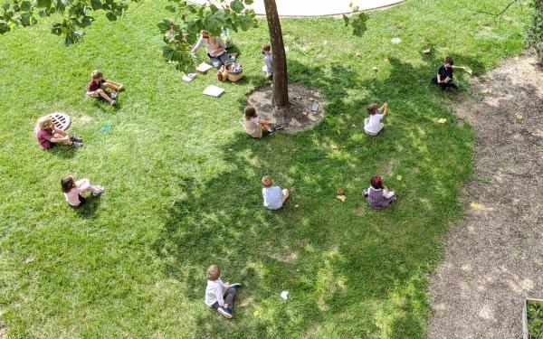 Students sitting on grass – outdoor class