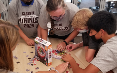 Freshmen work on a jigsaw puzzle
