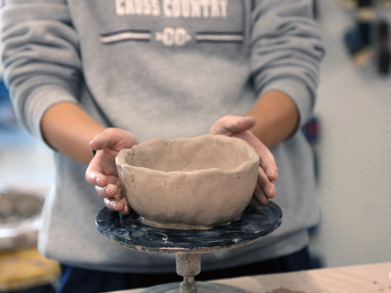 Columbus Academy student creating a ceramic pot